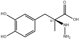 (S)-2-ヒドラジノ-2-メチル-3-(3,4-ジヒドロキシフェニル)プロパン酸 化学構造式