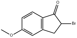 2-ブロモ-5-メトキシ-1-インダノン 化学構造式