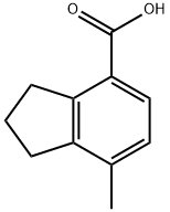 2,3-ジヒドロ-7-メチル-1H-インデン-4-カルボン酸 化学構造式